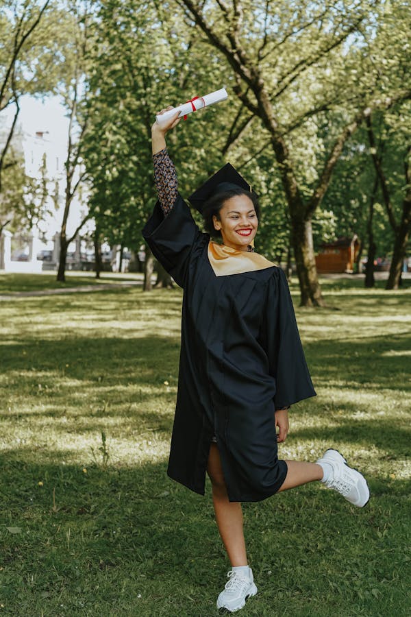 Student holding a diploma after completing their university programme